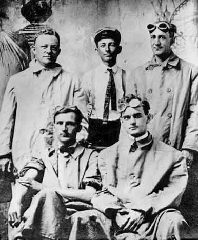 Five Dorris principals in driving coats and goggles, photographed in the early 1900s.